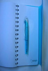 spiral notebook with pen