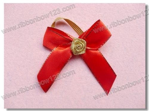 red bow with gold border and flower middle for red wine packaging
