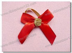 red bow with gold border and flower middle for red wine packaging