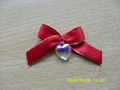 gold-trimmed polyester ribbon bow with heart-shaped crystal