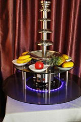 Rotatable illuminated base for chocolate fountain