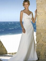 Beach wedding gown features in satin and drapes in a modified silhouette