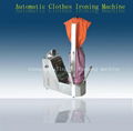 Automatic clothes ironing machine for