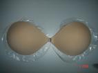 Seamless bra with adhesive