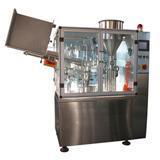 Tube filling and sealing machine