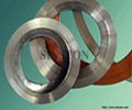 Corrugated metal gasket with outer ring
