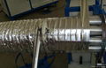 Flexible aluminum foil duct machine 10