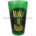 colored pint glass with gold logo