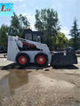 Pickup sweeper for skid steer loader