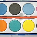 a palette with 12 colors watercolor and a brush 3