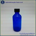 2oz Blue Boston Round Glass Bottle with  Phenolic Cap 