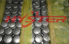 laminated wear buttons for bucket wear protection