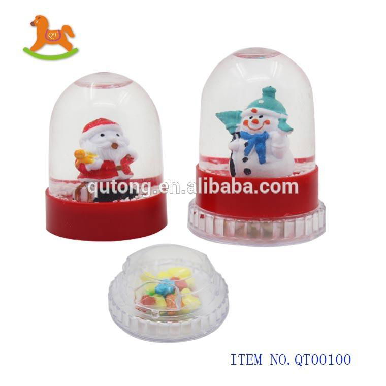 Hot selling revolving plastic Christmas ball toy with sweet   candy in display