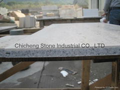 Natural stone laminated with granite and