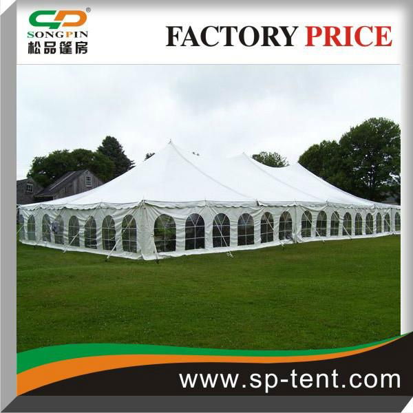 12x24m Pole Tent with Windows and Sides Secured to Grass Ground by Pegs and Rope