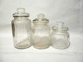 Transparent glass canister bottle with vertical grain and glass lids 1