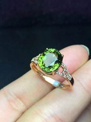 Classical natural green tourmalines 18k gold ring set with diamonds.