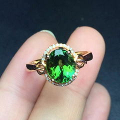 Natural green tourmaline 18k gold ring set with diamonds.