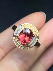 Natural red tourmaline 18k gold ring set with diamonds.