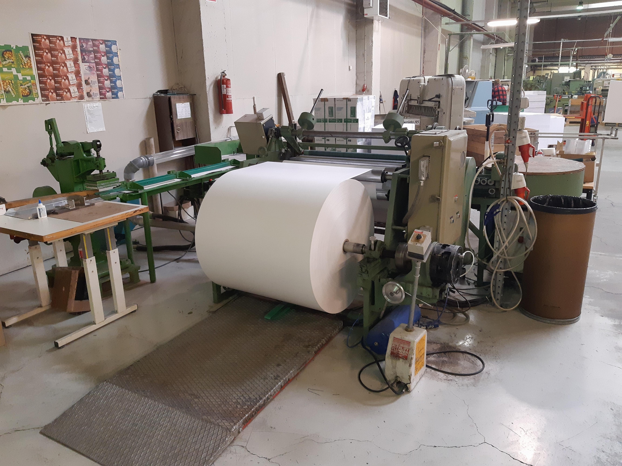 Slitter and rewinder for ATM paper rolls