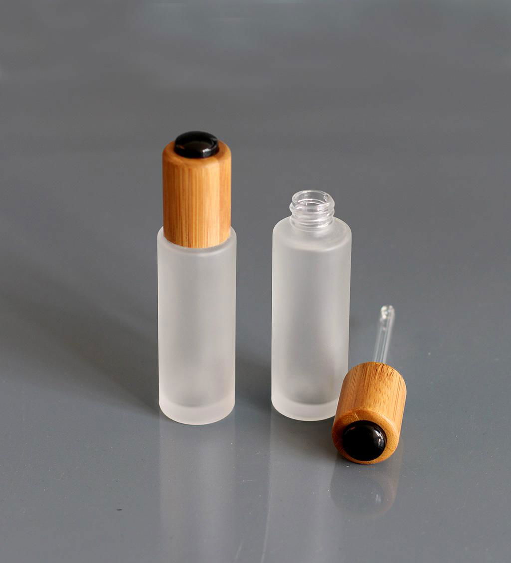 Essential bottle with bamboo dropper cover