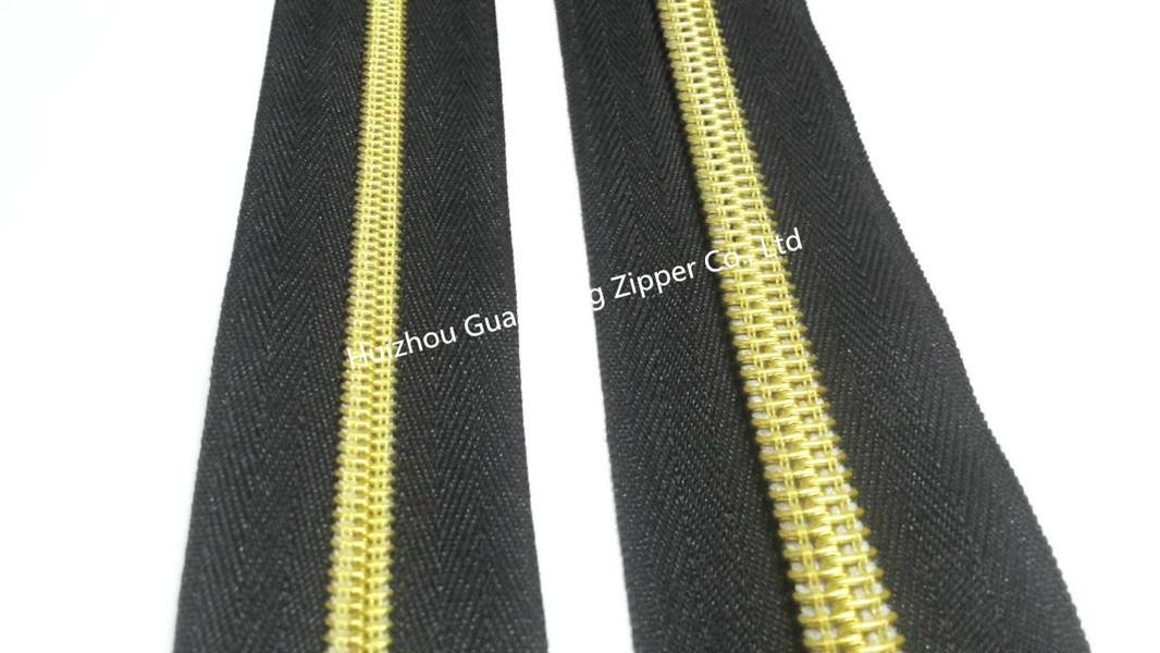 10# man pattern nylon zipper with black tape and golden teeth