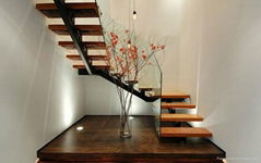 Contemporary wood staircase with glass railing