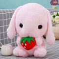 Plush toy holding strawberry rabbit