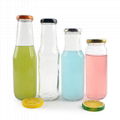 Empty clear glass tomato sauce beverage juice bottles with sealed metal cap