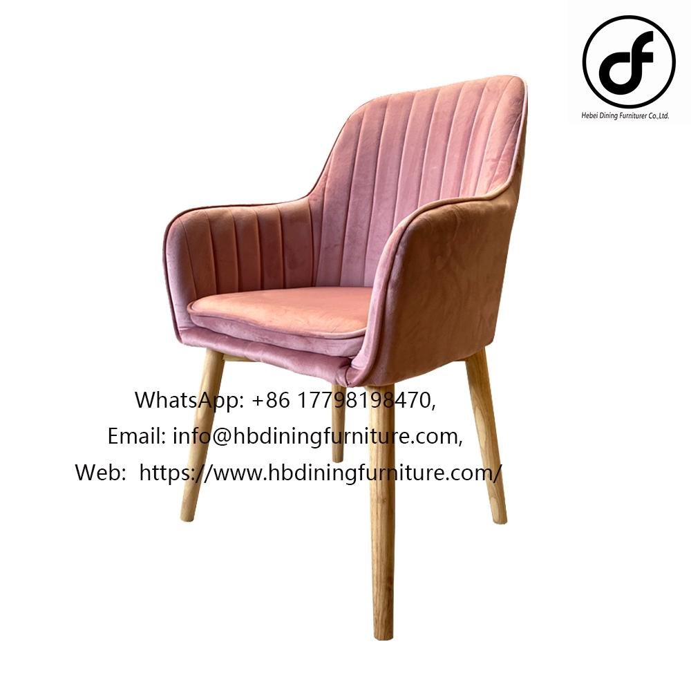 Elegant velvet armchair with wooden legs