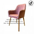 Elegant velvet armchair with wooden legs