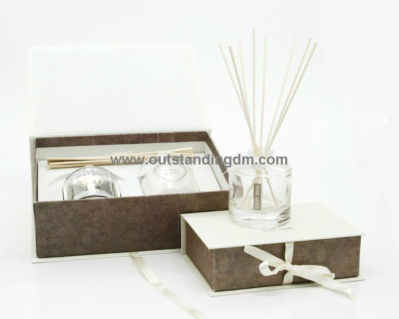 glass bottle with stopper and ribbon and rattan sticks