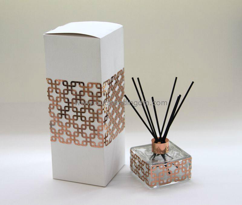 reed diffuser in clear glass bottle wrapped with rosegold  laser cut paper  inner seal  aluminium cap