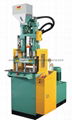 Small vertical injection molding machine