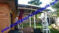 Double aluminium carport with white frame and blue polycarbonate solid roofing