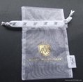 Custom white organza jewelry pouch with golden hot stamping logo in center